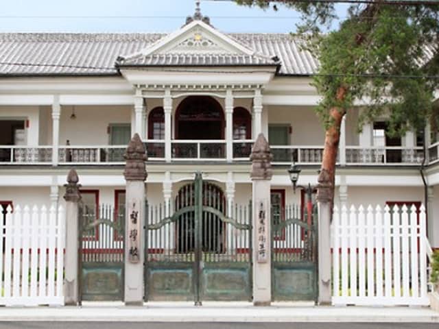 明治時代の洋風建築様式を取り入れた白亜の旧官公庁建物の正面と門構え。